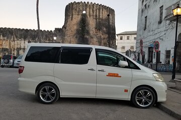 Kai Tours and Safaris private Toyota Alphard parked by the fort in Stone Town, Zanzibar