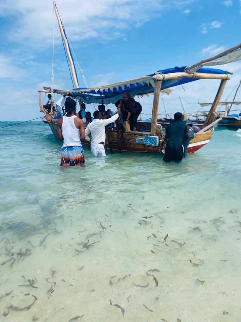 Guests on a traditional dhow cruise on the Indian Ocean in Zanzibar