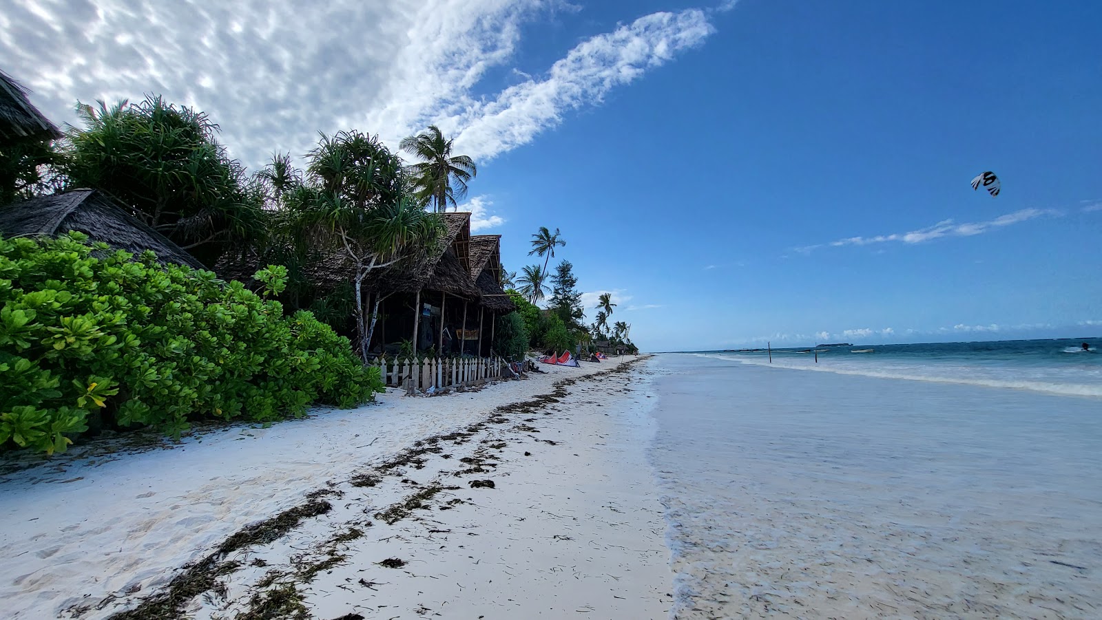 Wide quiet beach with thatched bandas on the east coast of Zanzibar at Matemwe and Jambiani