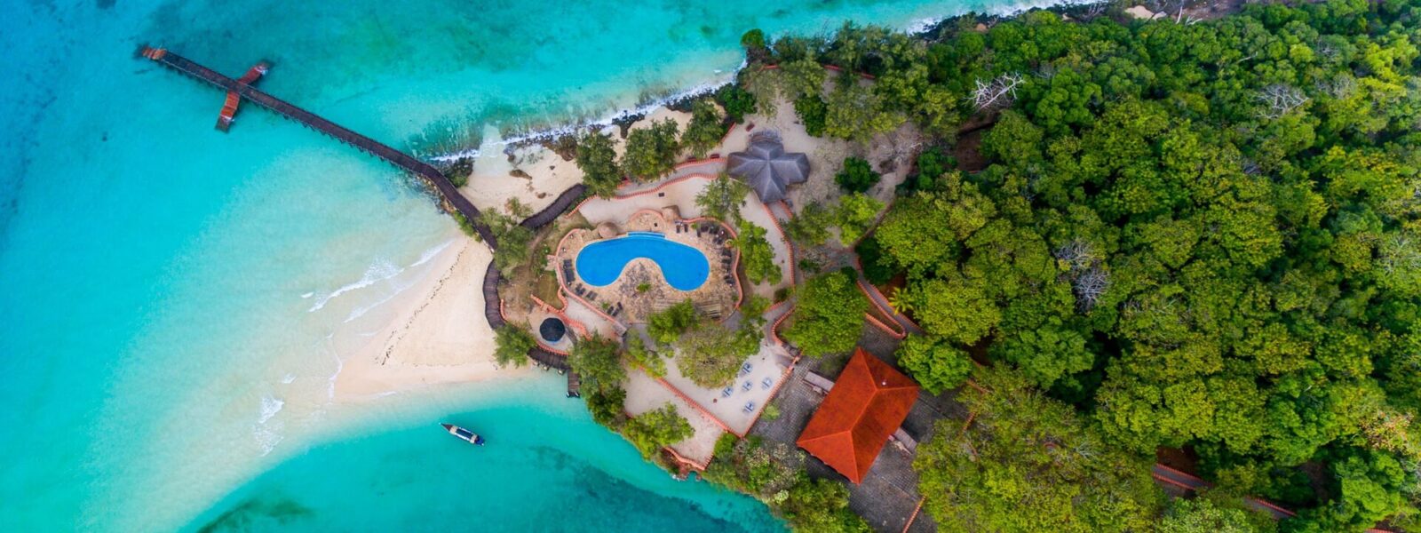 Aerial view of Prison Island with its beach, jetty and turquoise lagoon near Zanzibar