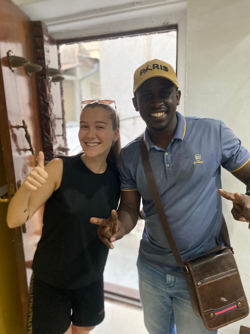 Kai Tours and Safaris guest at a carved Zanzibari door on a Stone Town tour