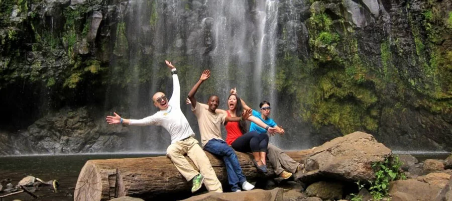 Scenic view of Marangu Waterfalls on the slopes of Mount Kilimanjaro with lush green forest surroundings