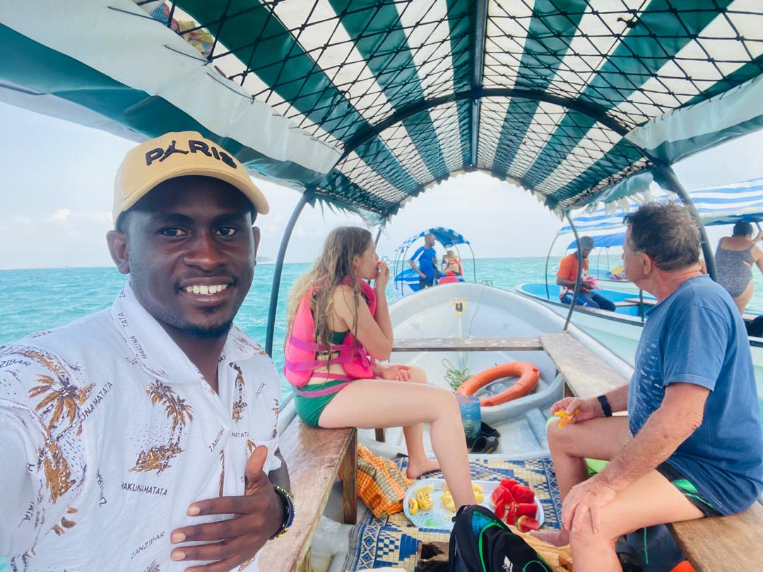 Kai Tours and Safaris guide with happy guests on a Zanzibar boat excursion
